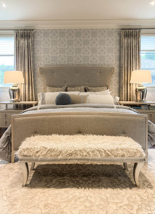Luxurious bedroom with upholstered bed, bench, and patterned wallpaper. Interior Design Services Burlington. Bedroom Furniture.