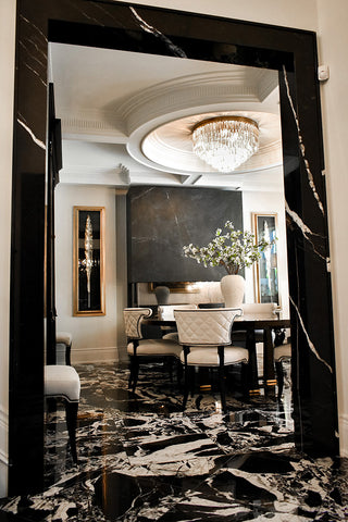 Looking into a luxe black and white dining room