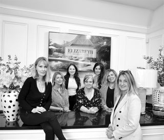 Store team image of seven women
