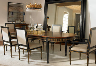 Dining room with a wooden table and chairs, large mirror, and decorative elements.