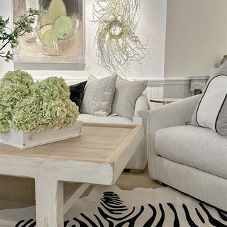 bright room image with white couches and a cream coffee table