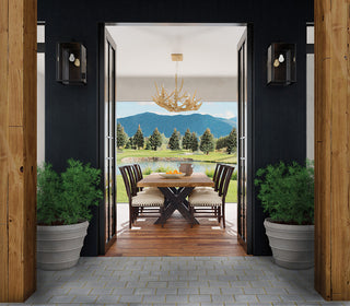 An image of an opening looking at a dining table set with beautiful greenery in the back